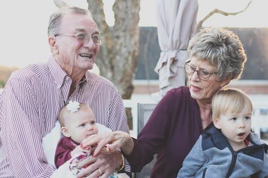 Grandparents with dementia holding babies